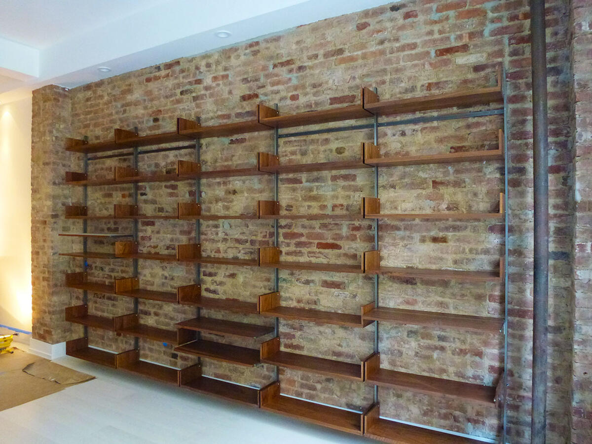 Work in progress built in bookshelf on a brick wall