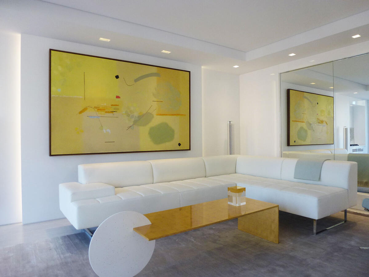 Wall with collage of dogs on brown canvas with a bookshelf to the right