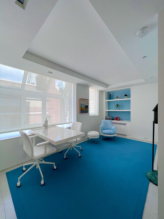 A white soaking bathtub in a brightly lit bathroom