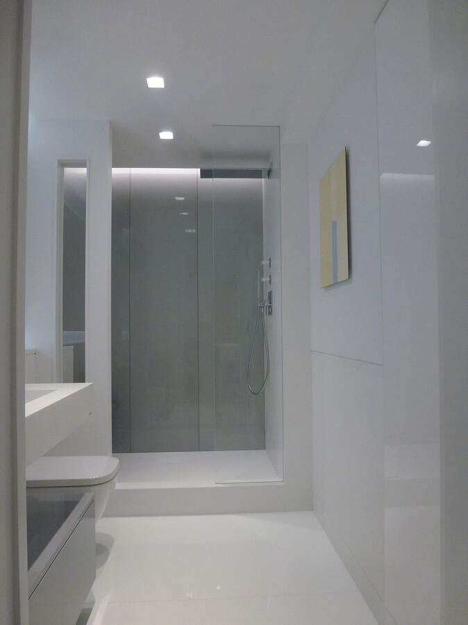 Brightly lit white kitchen with marble counters