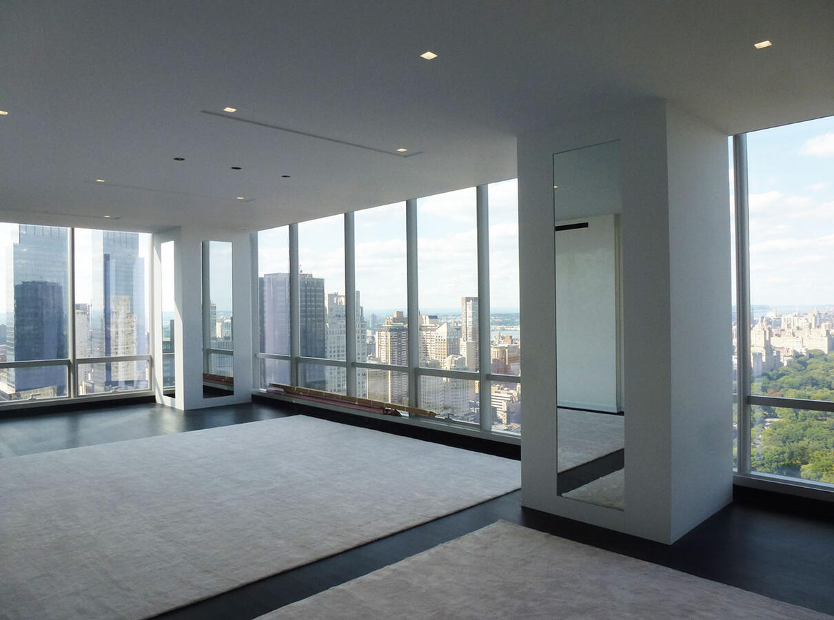 Wall with collage of dogs on brown canvas with a bookshelf to the right