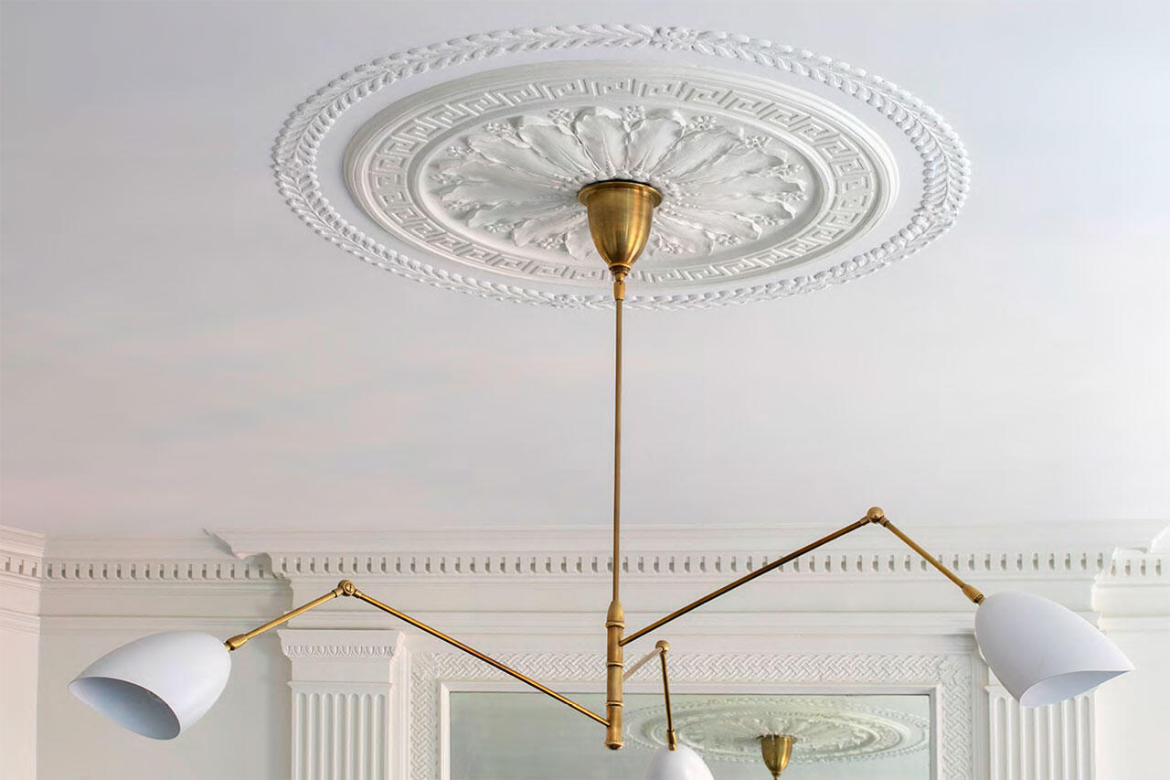 Brightly lit white kitchen with marble counters