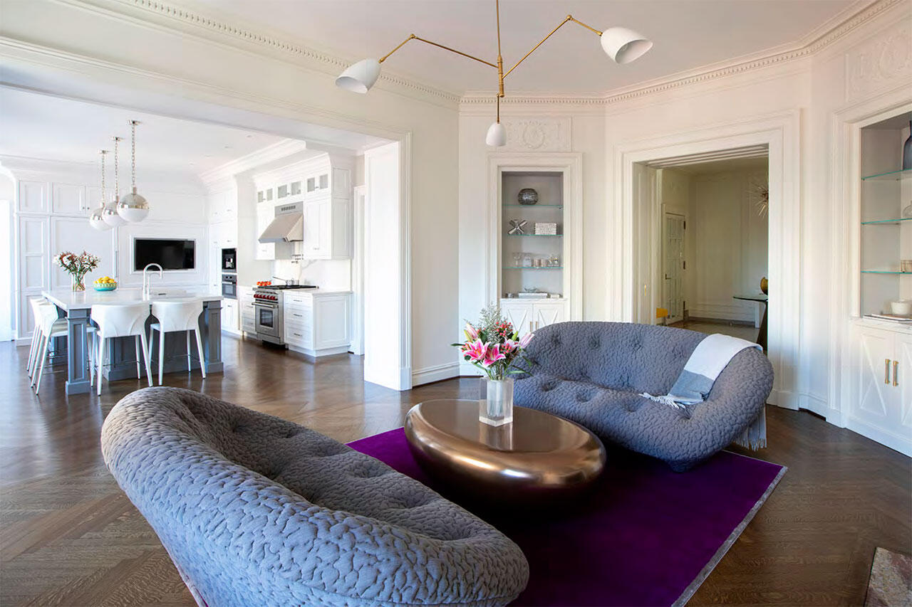 Bathroom stall with wooden paneled floors and a foldable wooden seat