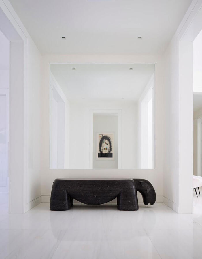 Bathroom stall with wooden paneled floors and a foldable wooden seat