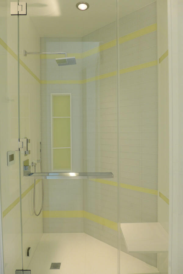 A white soaking bathtub in a brightly lit bathroom