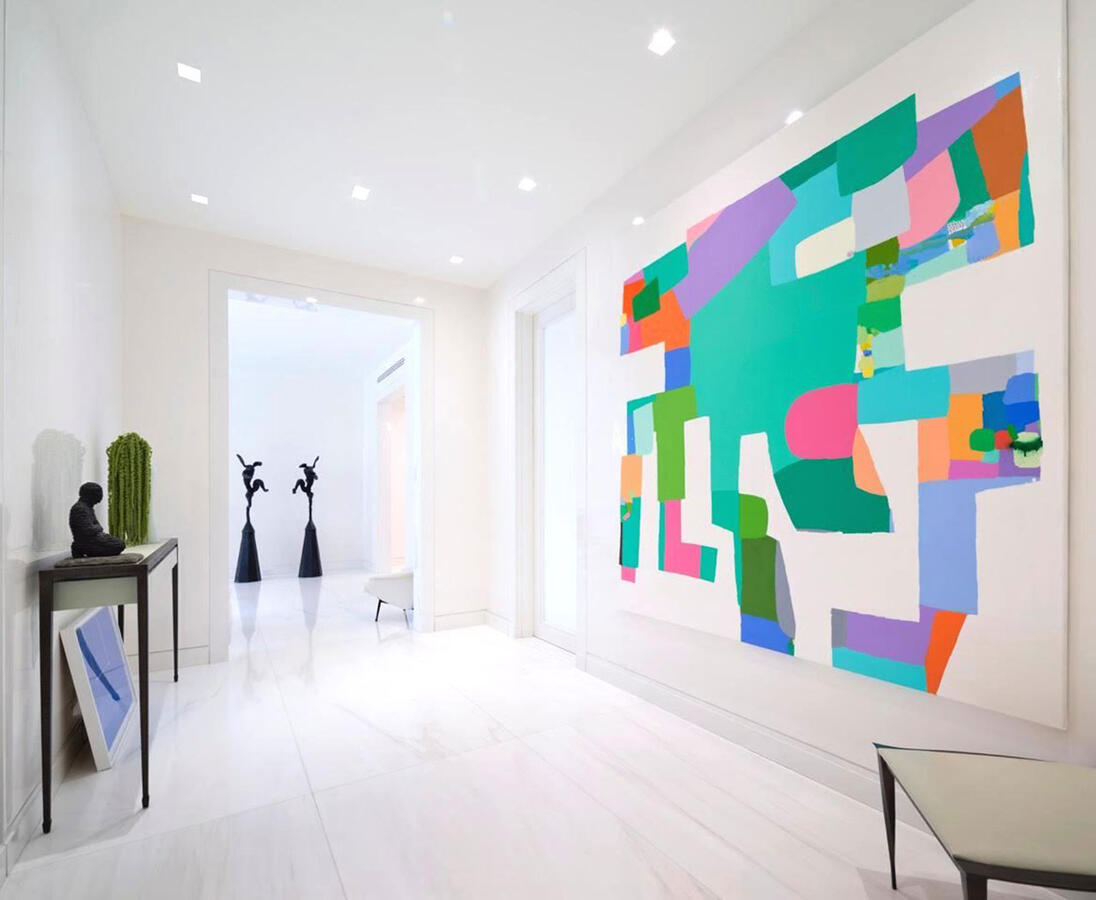 Brightly lit white kitchen with marble counters