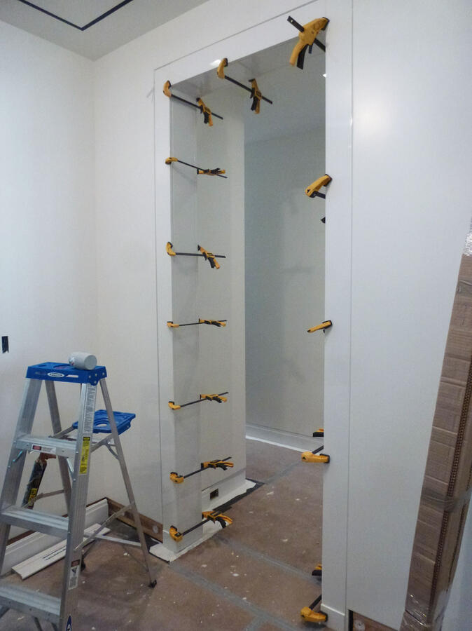 Brightly lit white kitchen with marble counters