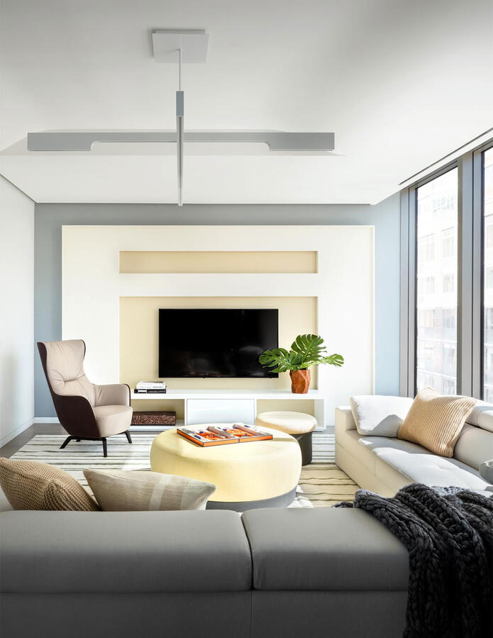 Wall with collage of dogs on brown canvas with a bookshelf to the right