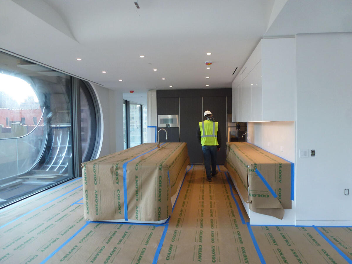 A white soaking bathtub in a brightly lit bathroom